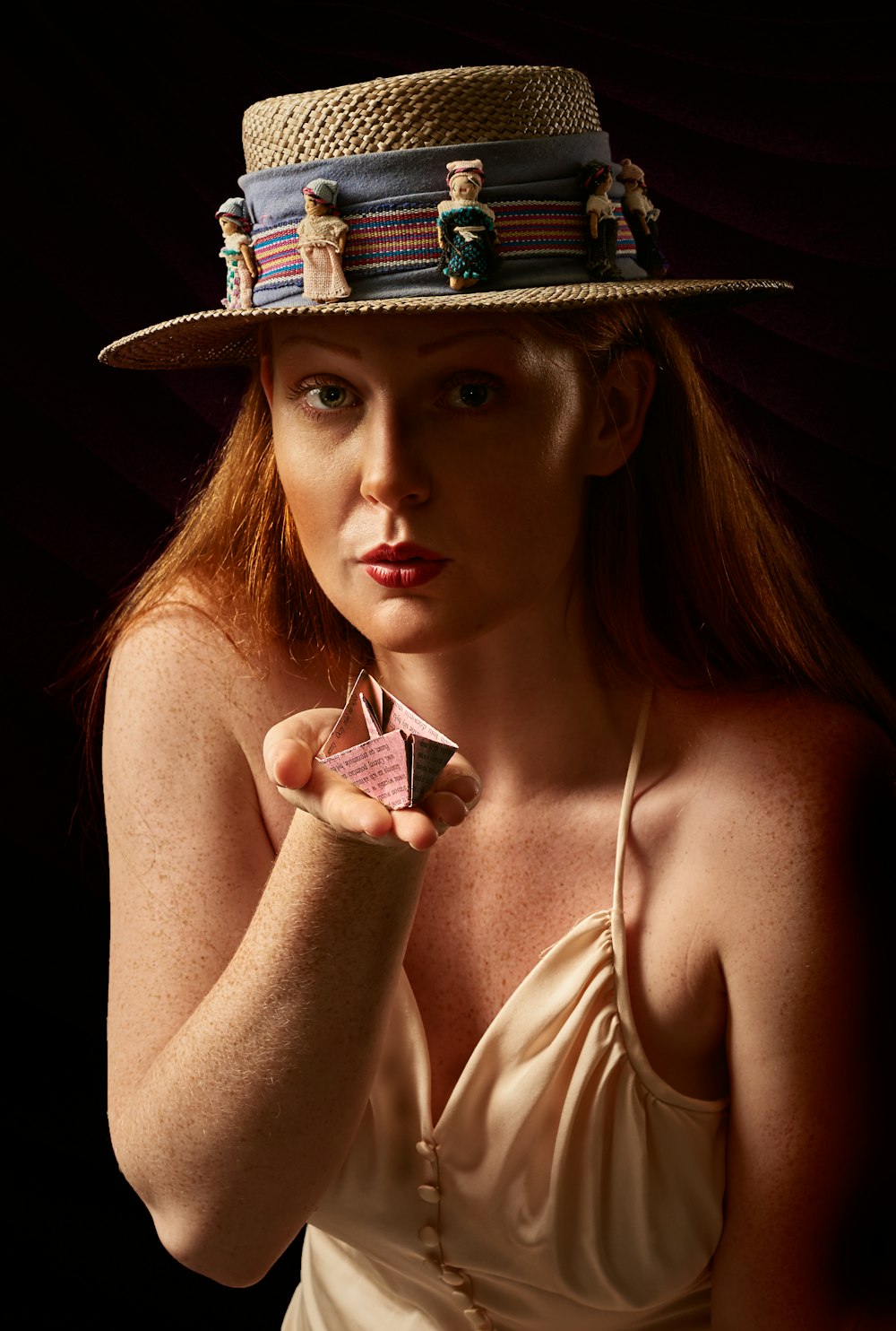woman wearing brown hat holding purple and white box