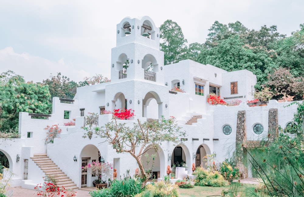 white concrete building near green trees during daytime