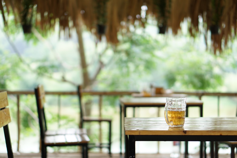 clear drinking glass on brown wooden table