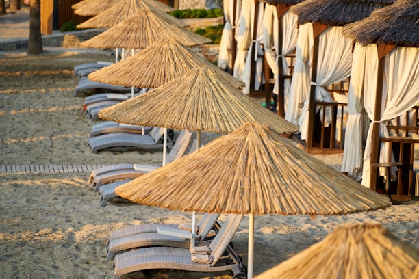 brown wooden boat on gray sand during daytime
