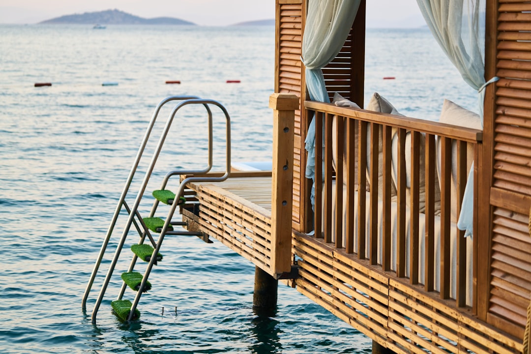 brown wooden bench on dock during daytime