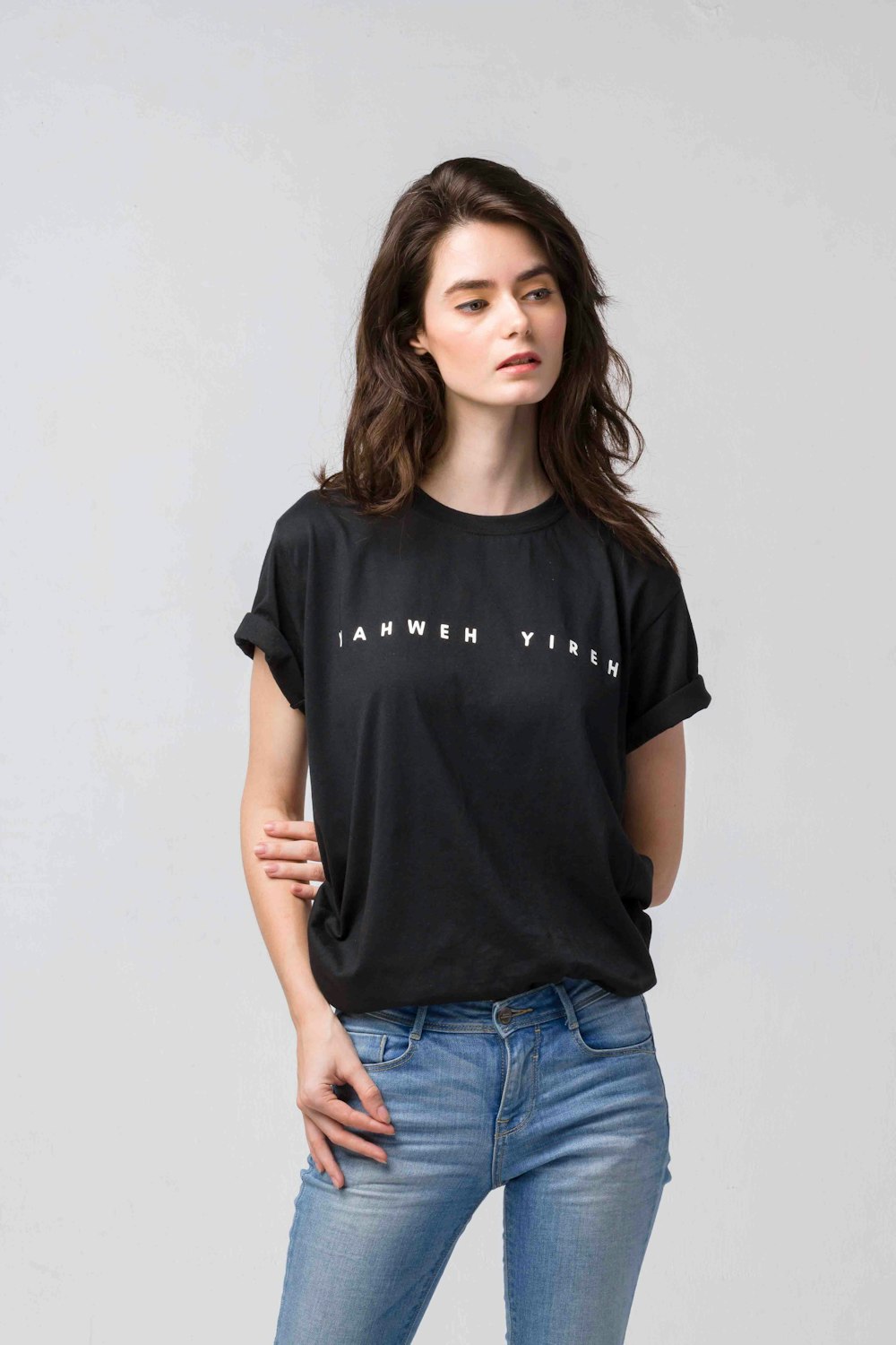 woman in black crew neck t-shirt and blue denim jeans