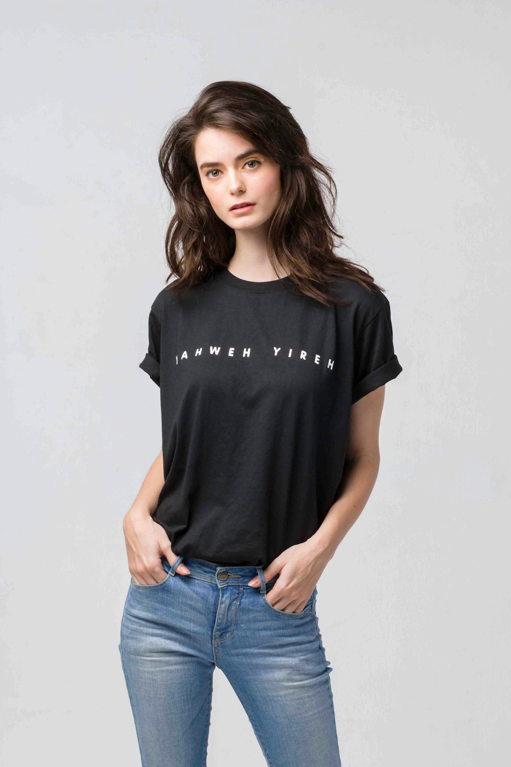 woman in black crew neck t-shirt and blue denim jeans