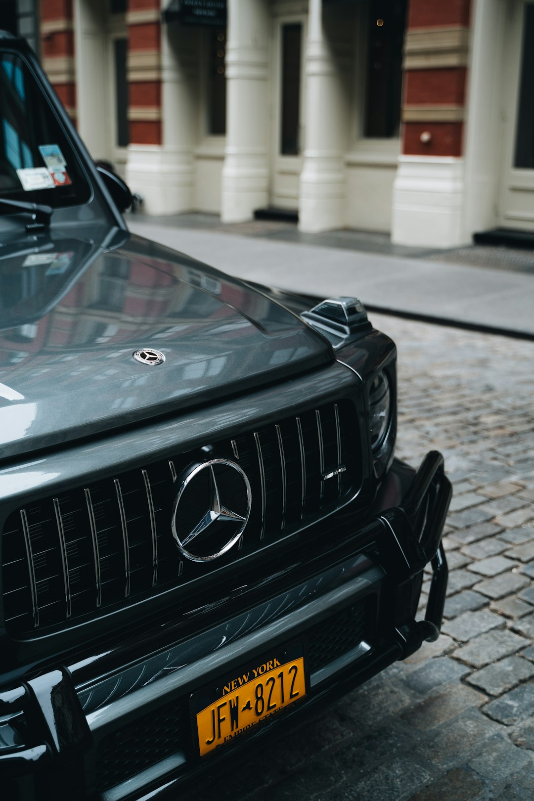 black mercedes benz car in front of white building