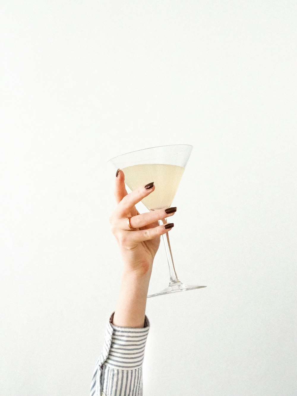 person holding clear drinking glass