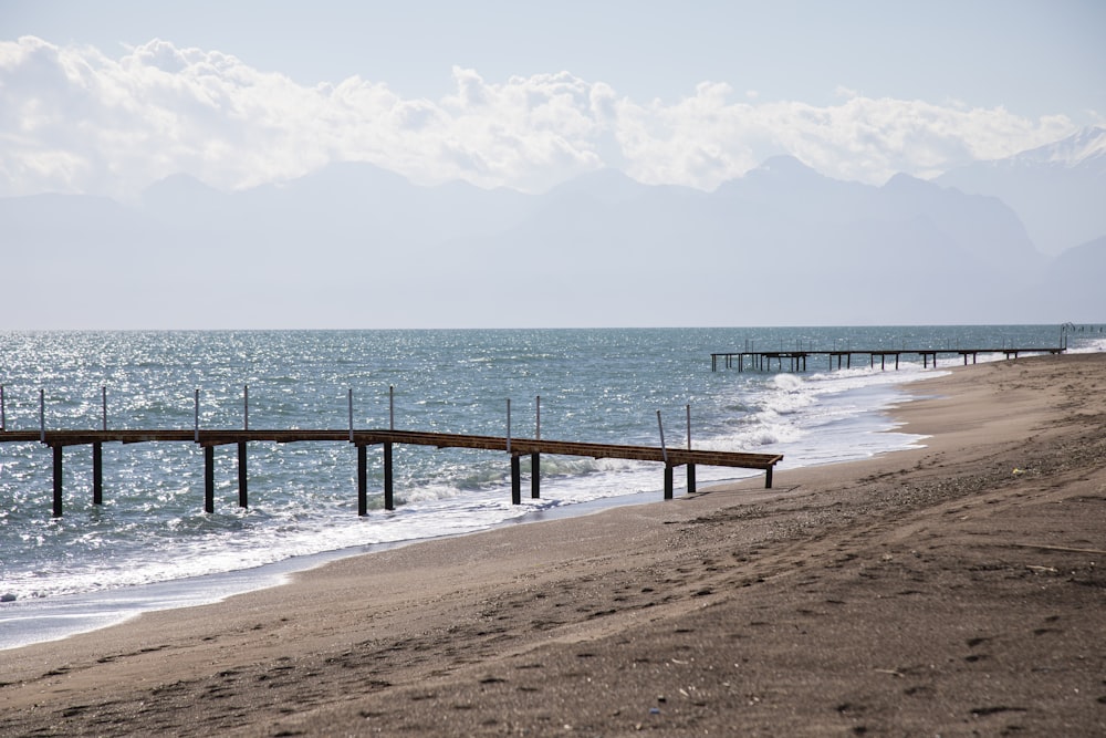 brown wooden dock on sea during daytime