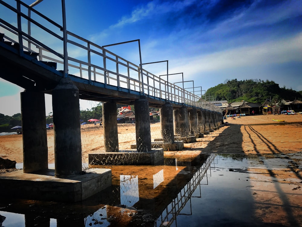 gray concrete bridge over river during daytime