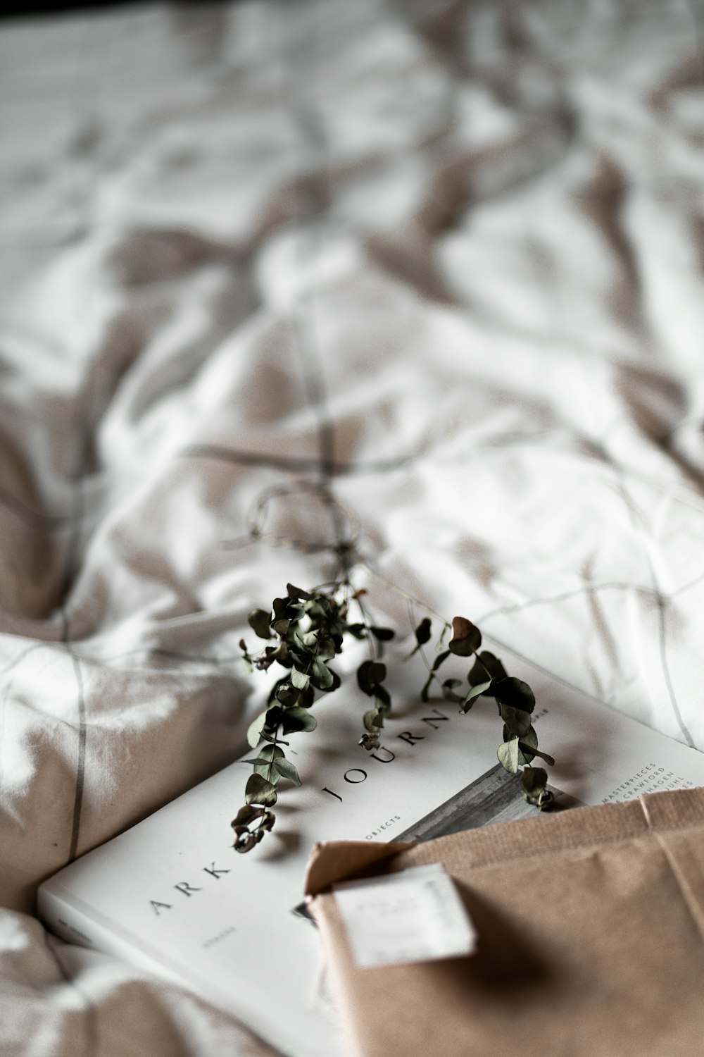 white and green flower bouquet on white and brown floral textile