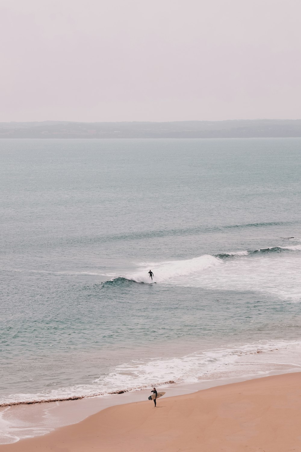 person surfing on sea waves during daytime