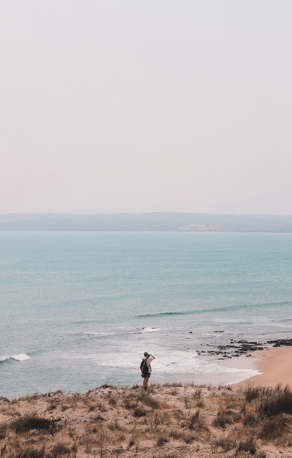 person walking on beach during daytime