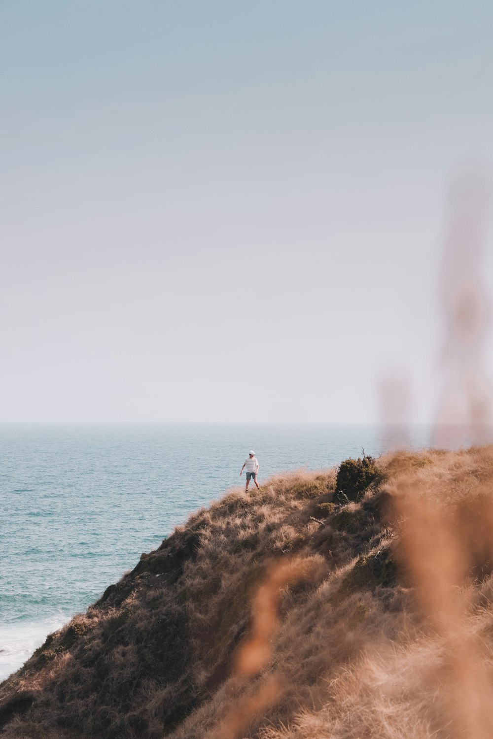 person standing on rock near sea