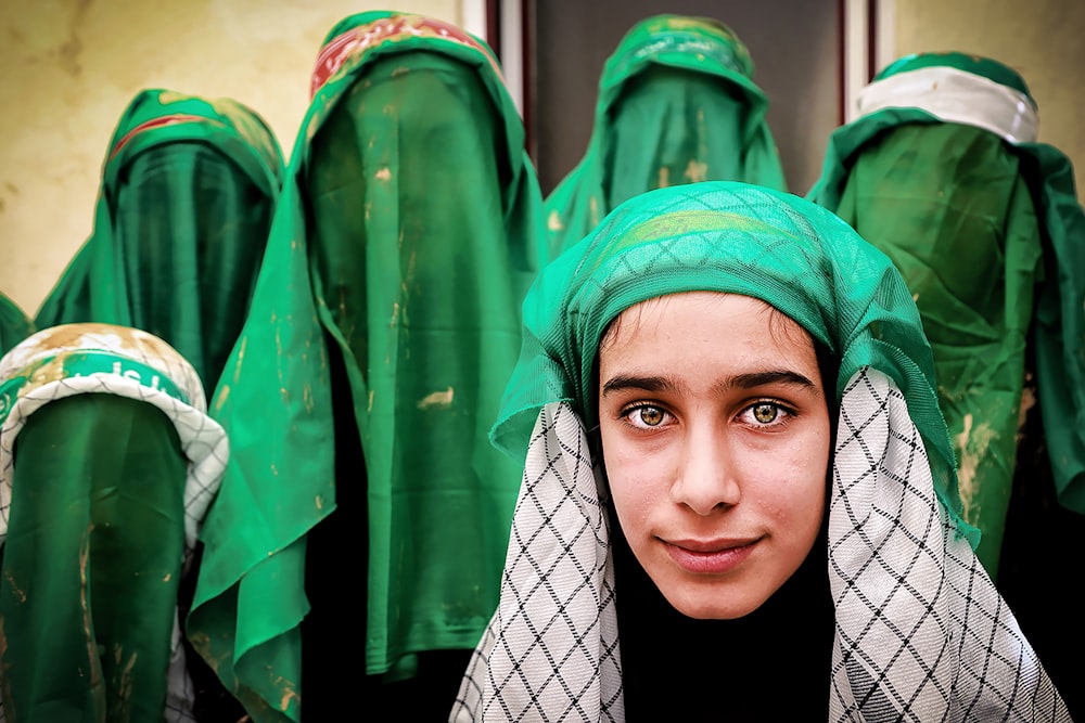 woman in green hijab and black and white hijab