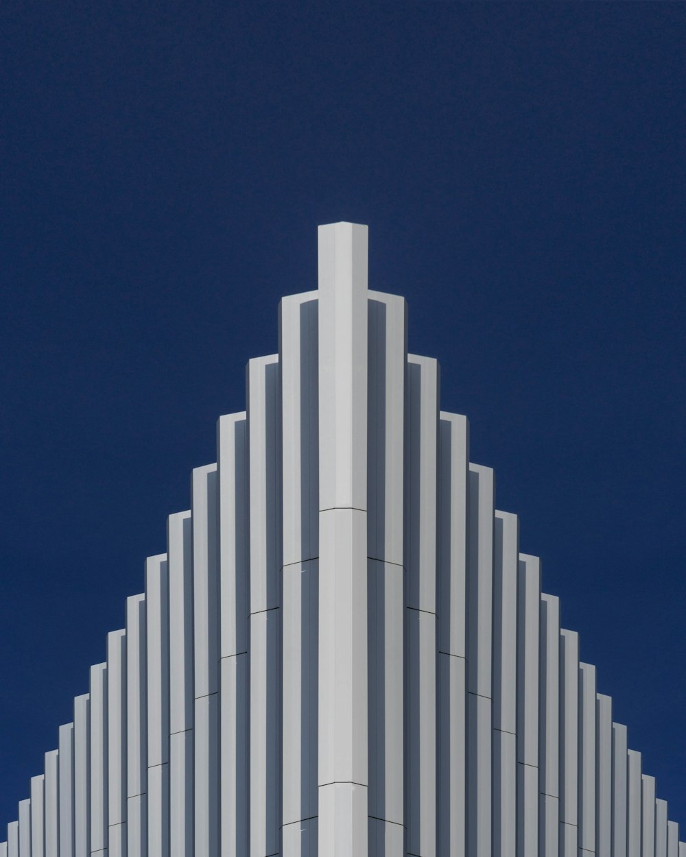 Bâtiment en béton blanc sous le ciel bleu pendant la journée