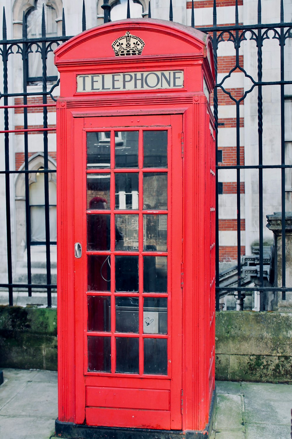 red telephone booth near building during daytime