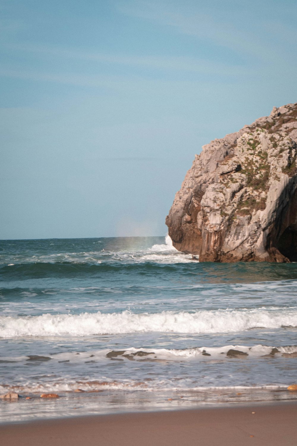 brown rock formation on sea water during daytime