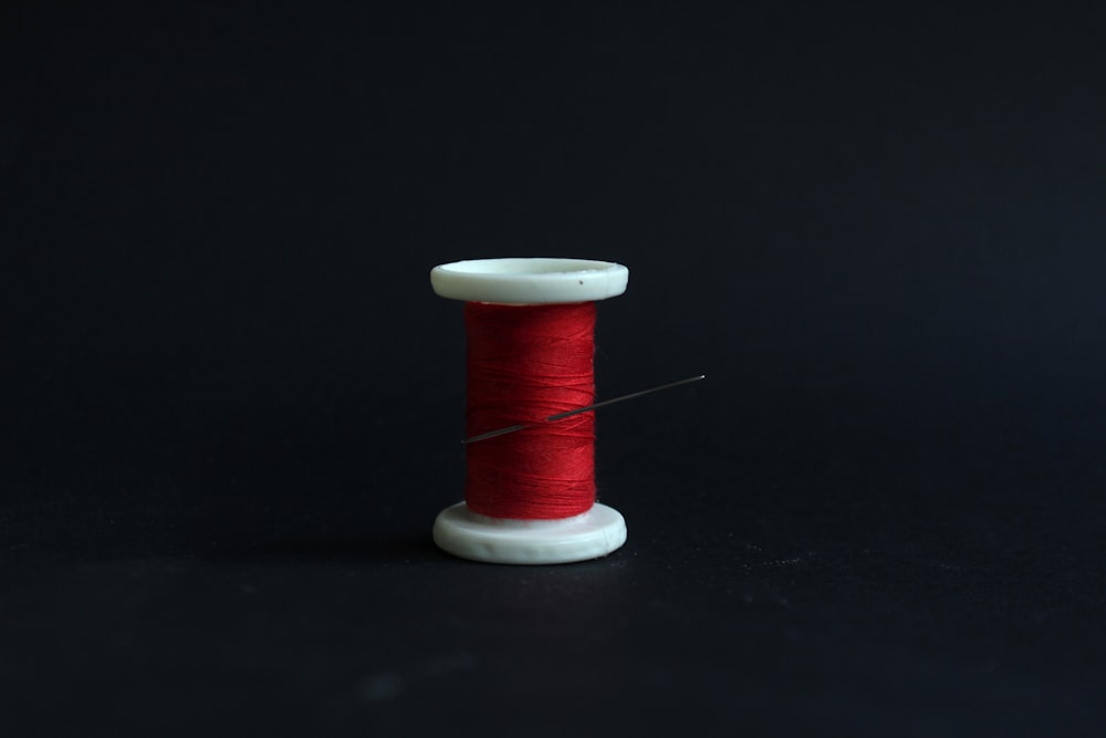 red thread on white spool