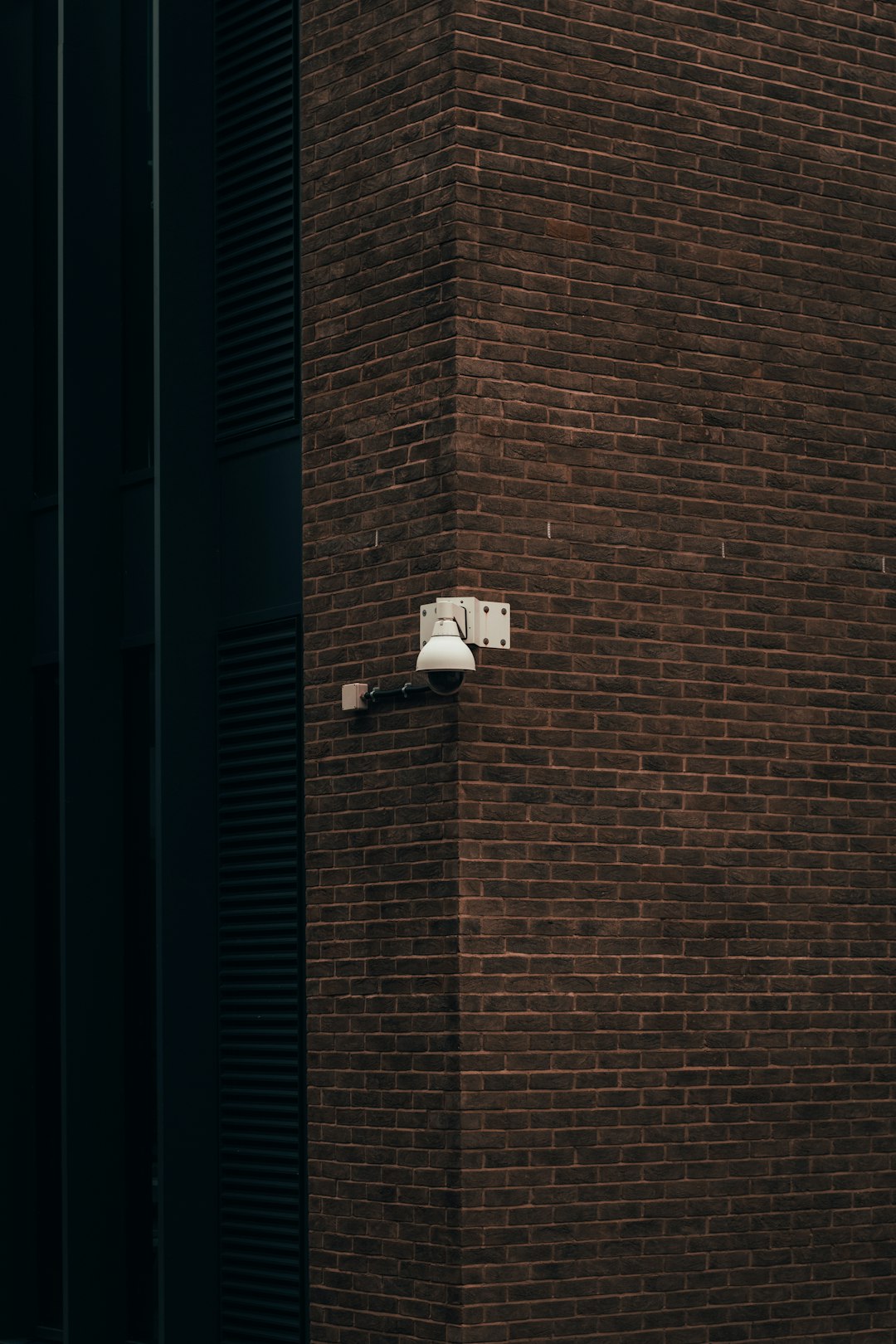 white wall mounted lamp on brown brick wall