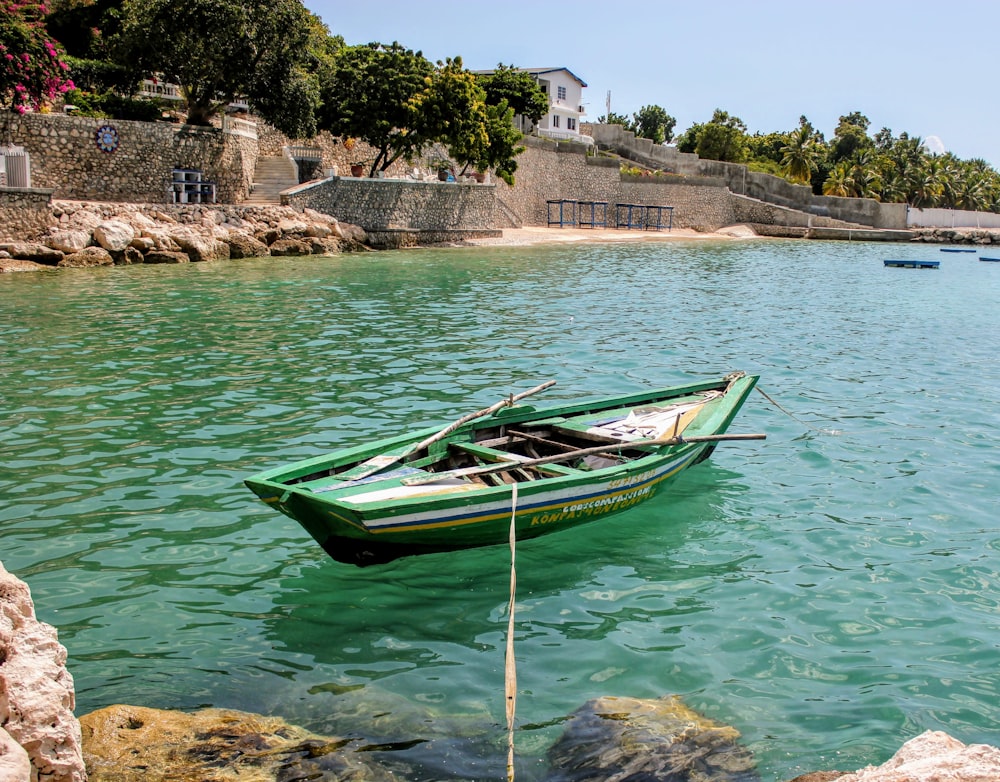 green and white boat on water