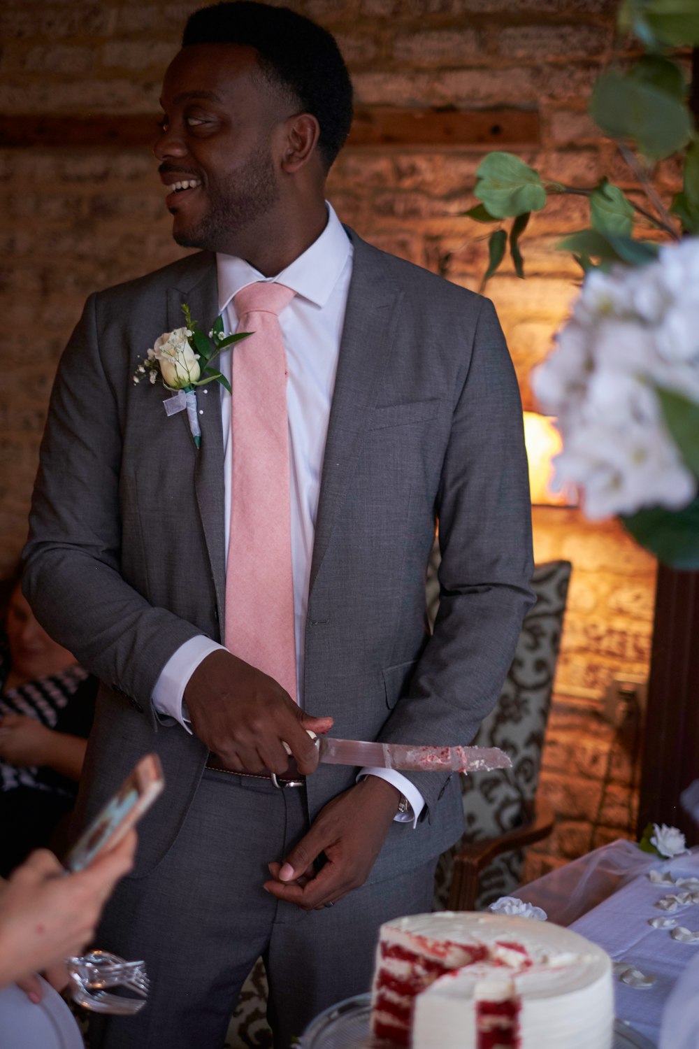 man in black suit holding white and brown stick