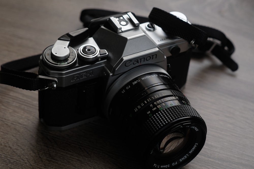 black nikon dslr camera on brown wooden table