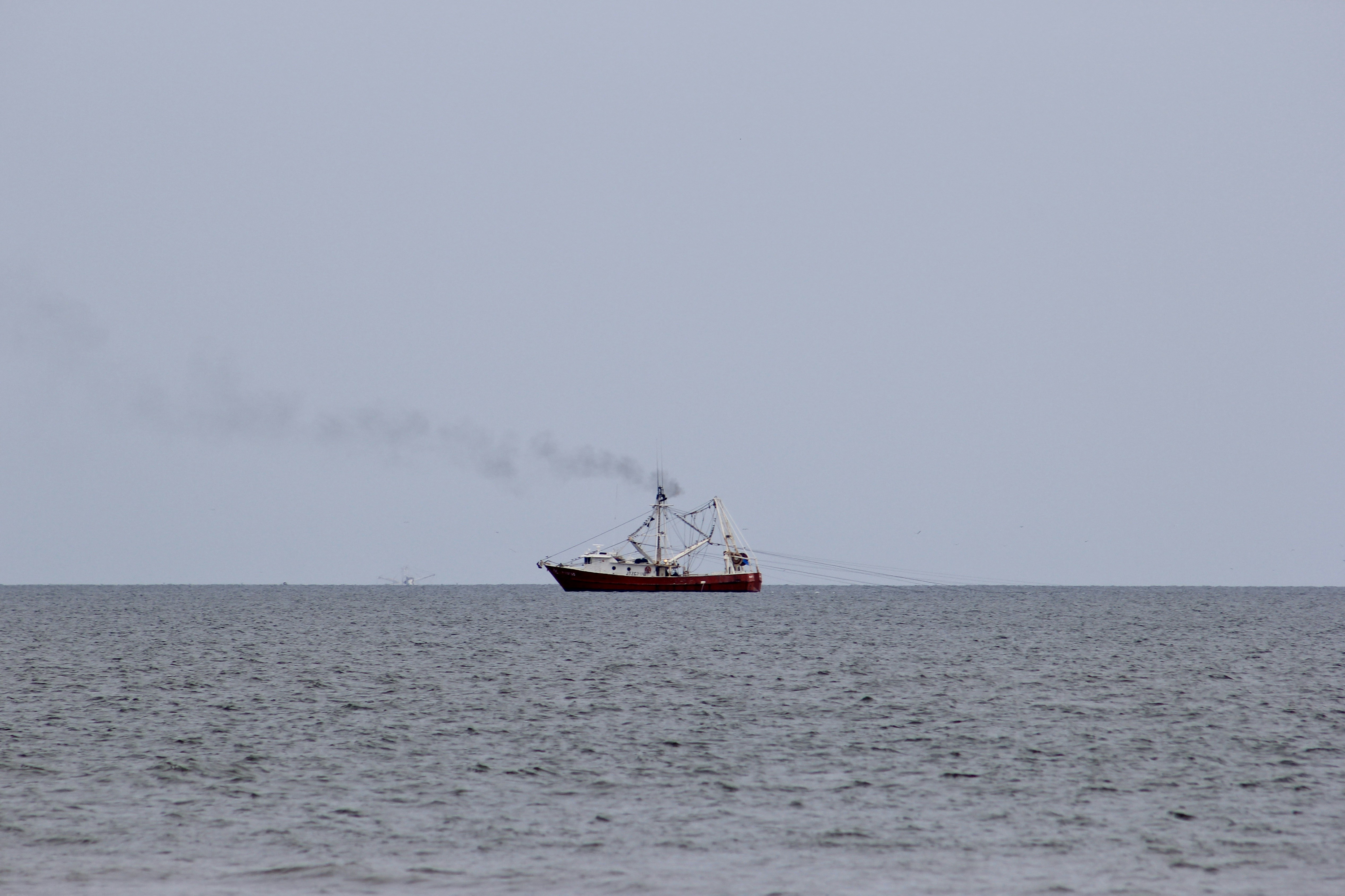 red boat on sea during daytime