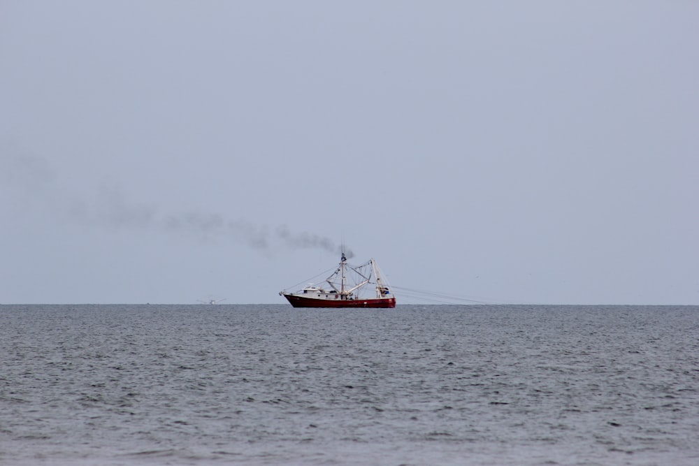 red boat on sea during daytime
