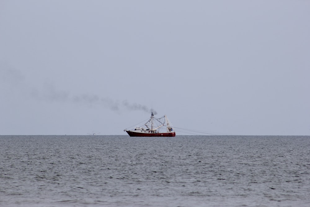 red boat on sea during daytime