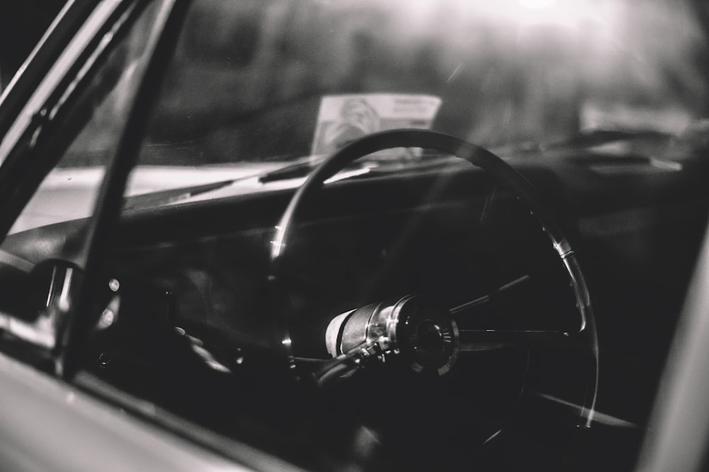 black car steering wheel with water droplets