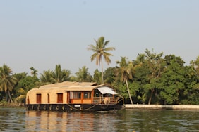 brown wooden house on body of water during daytime