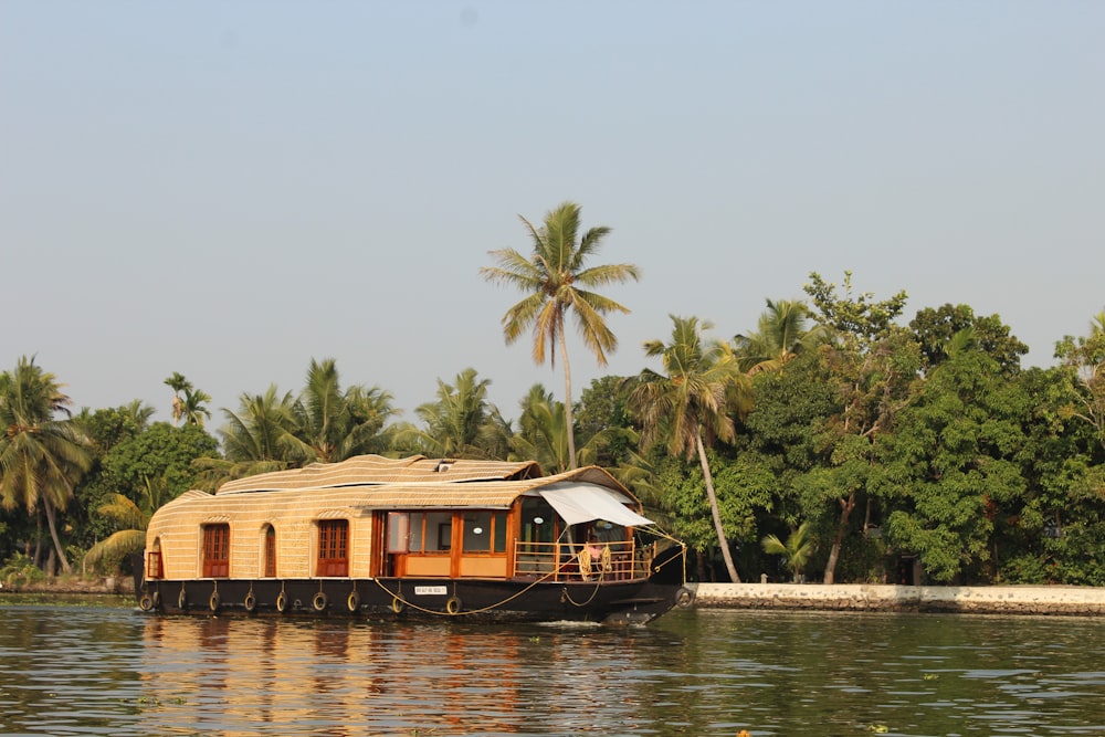 brown wooden house on body of water during daytime