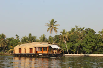 brown wooden house on body of water during daytime