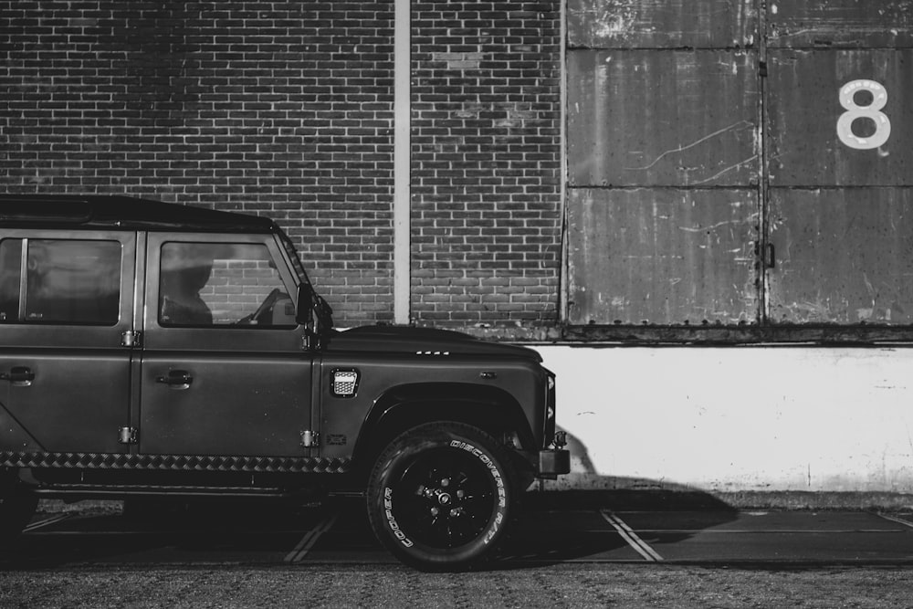 grayscale photo of car on road