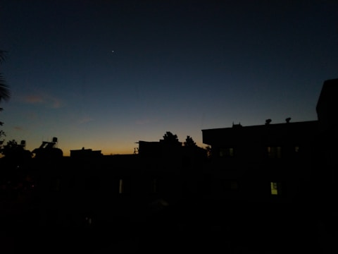 A minimalist digital sketch of a city skyline at dawn