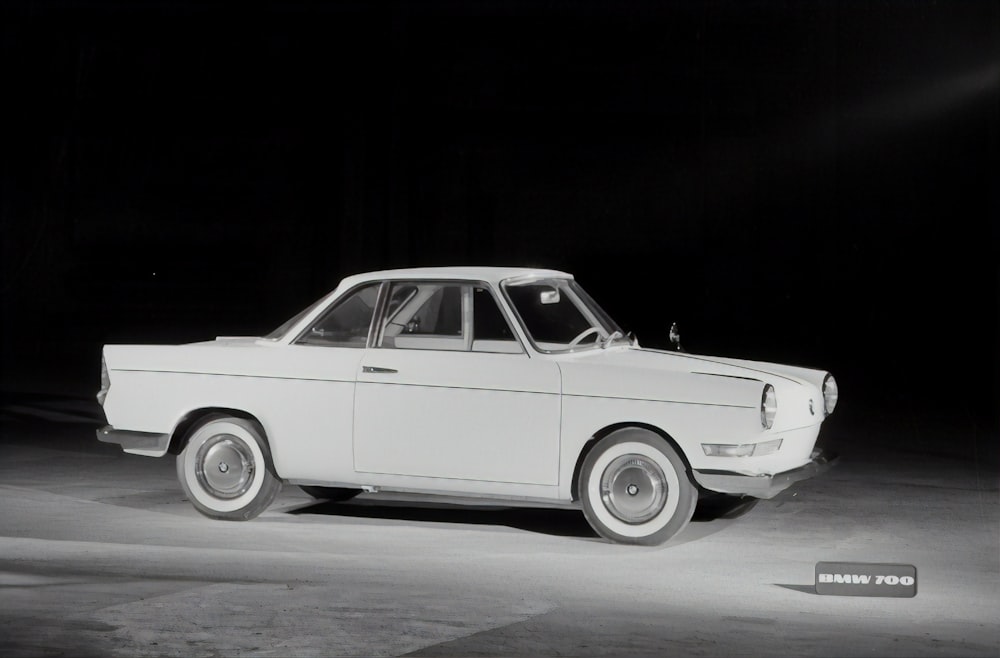 white vintage car on gray asphalt road