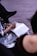 Close-up of a thoughtful person writing notes during a therapy session.