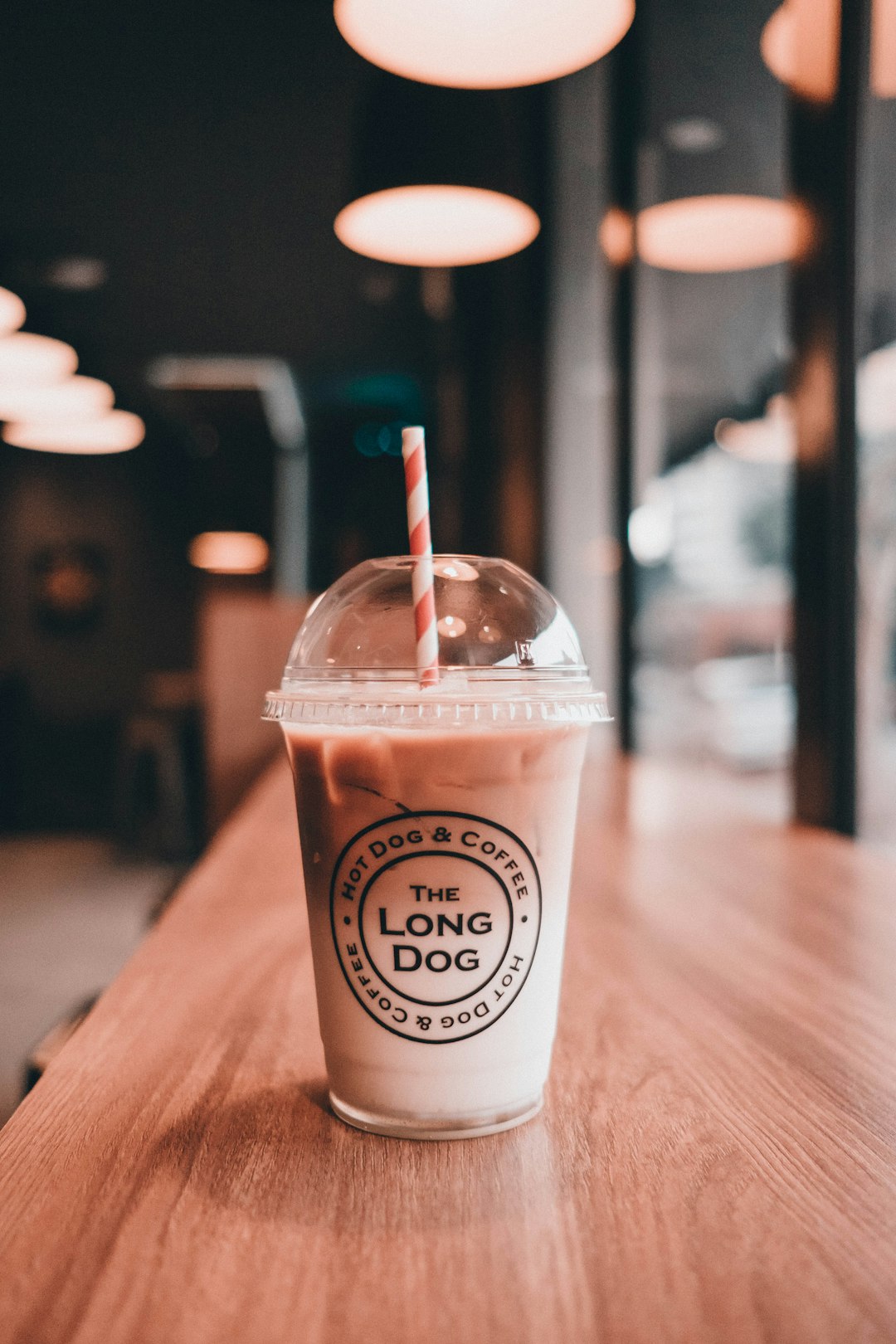 white and brown disposable cup on brown wooden table