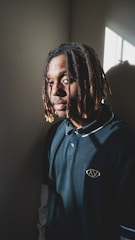 Young participants learning dreadlock techniques in a bright community room.