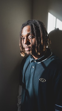 Young participants learning dreadlock techniques in a bright community room.