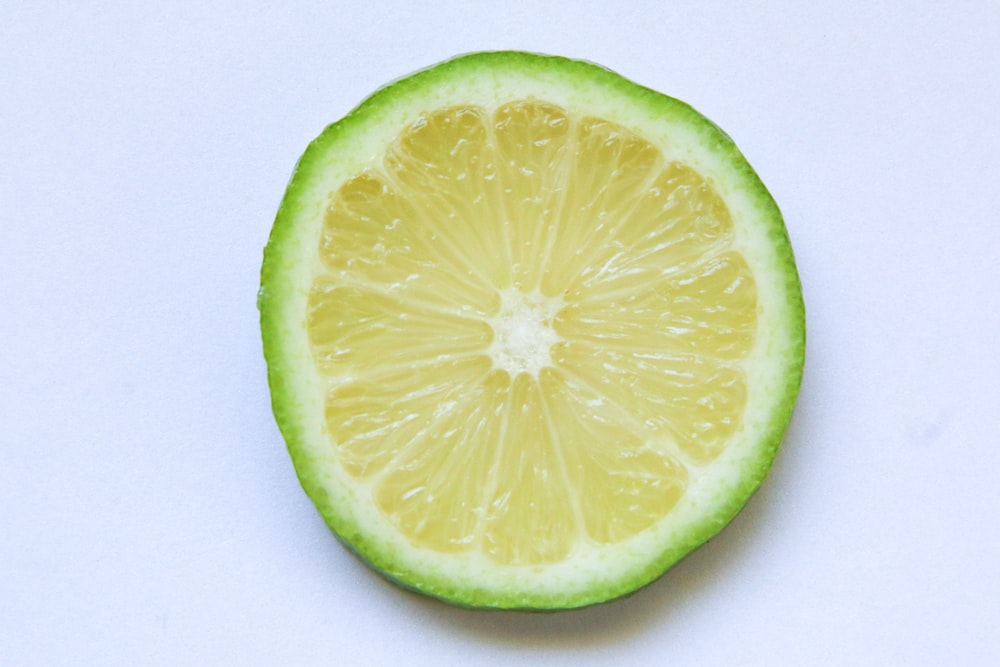 sliced lemon on white surface