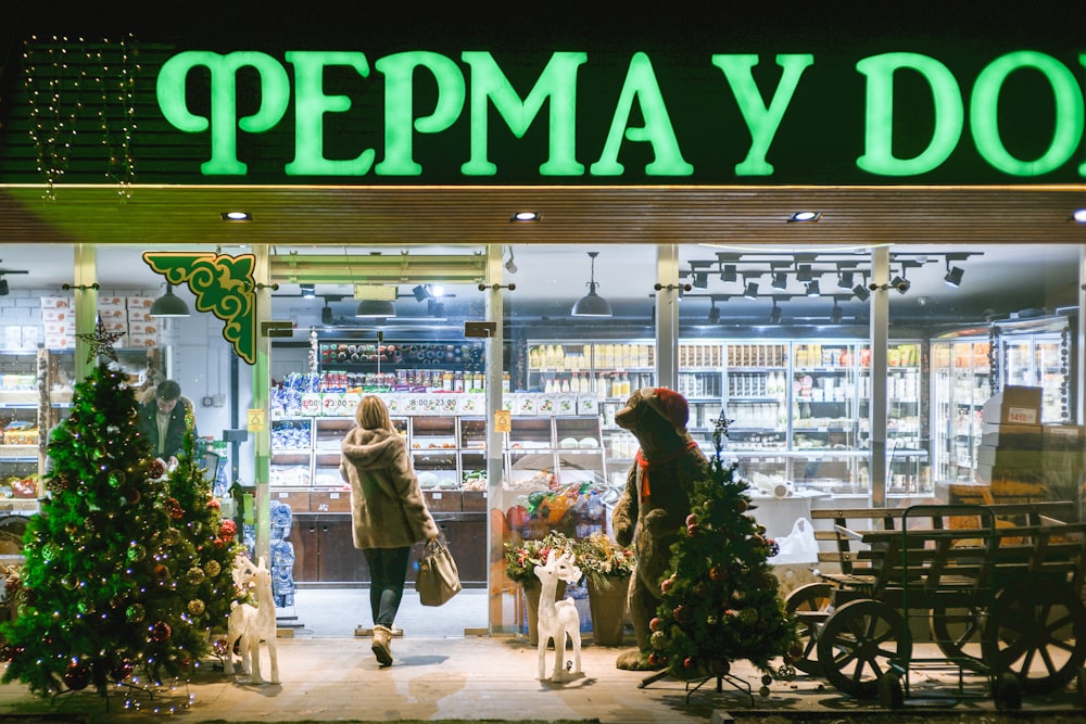 a store front with christmas trees and decorations