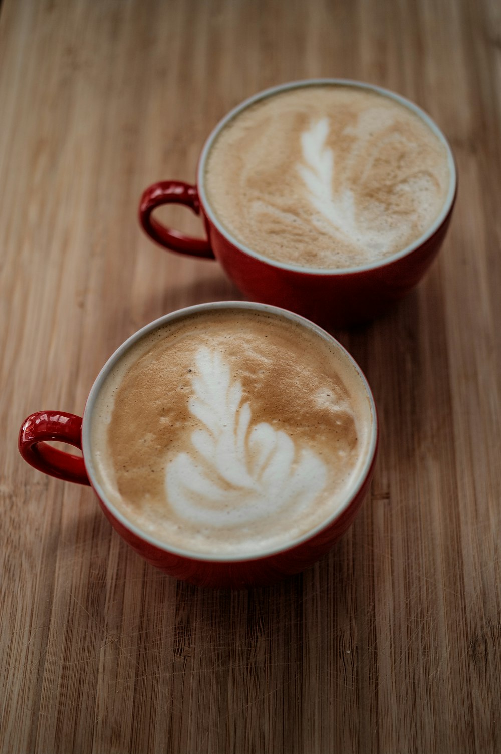 red ceramic mug with heart shaped coffee