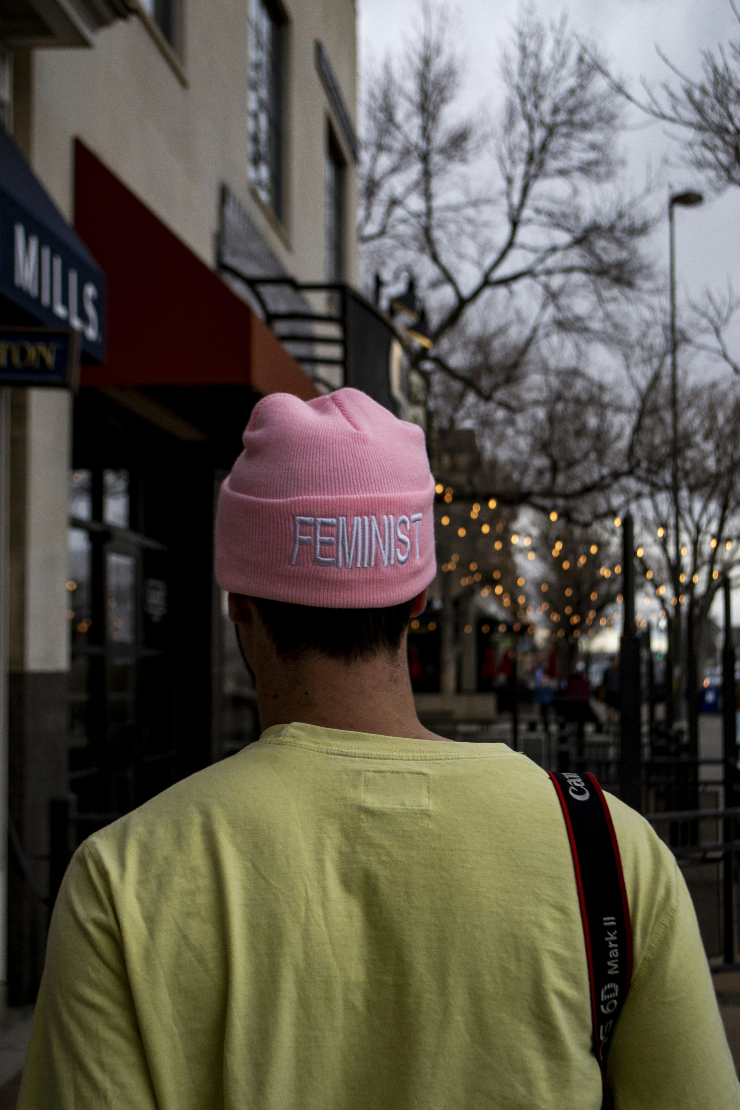 man in red knit cap and yellow crew neck shirt