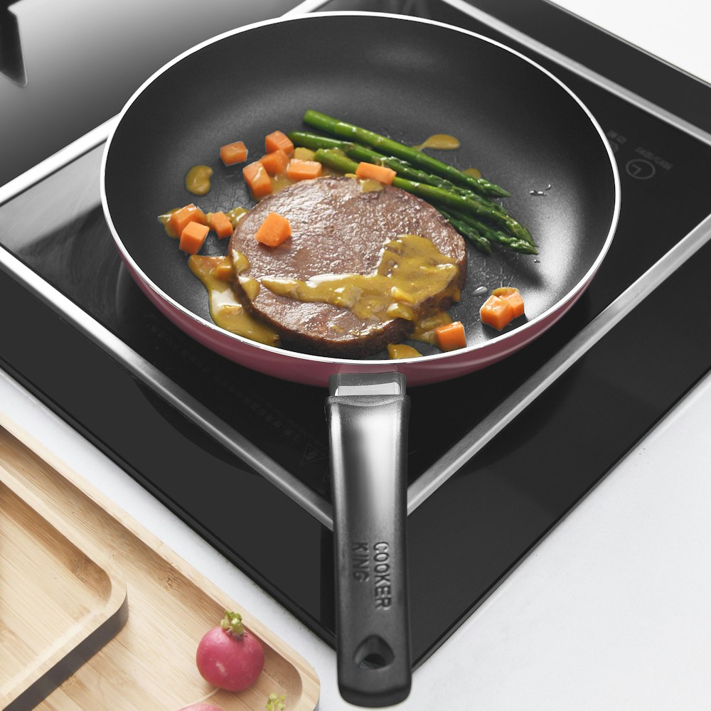 black frying pan with cooked food