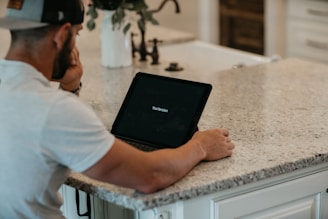 A person praying with a digital tablet in hand.