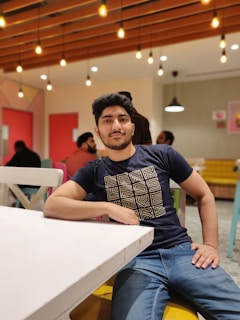 Young adult enjoying a casual meal in a cozy urban kitchen setting with eco-friendly decor.