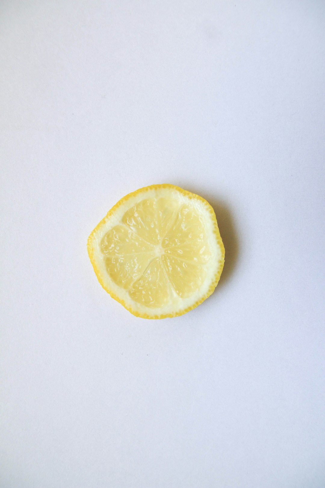 sliced lemon on white surface