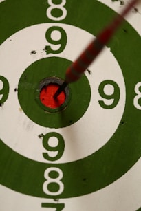 green white and black round with red line