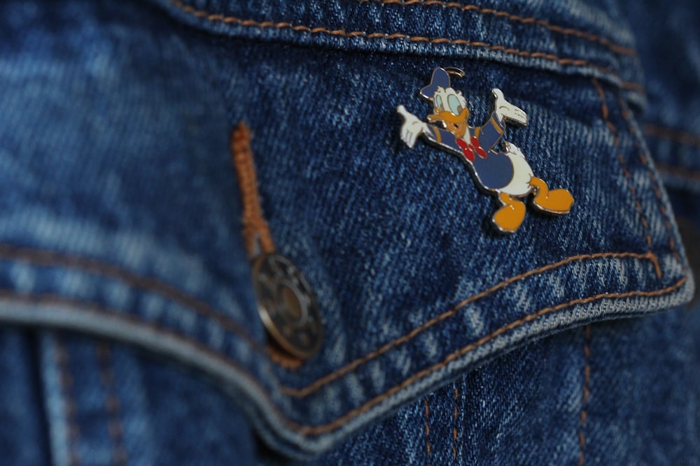 blue denim jeans with red and white bird print