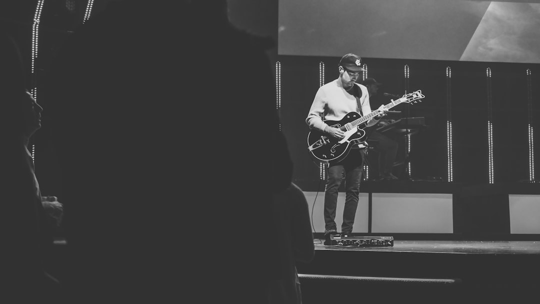 man playing guitar on stage