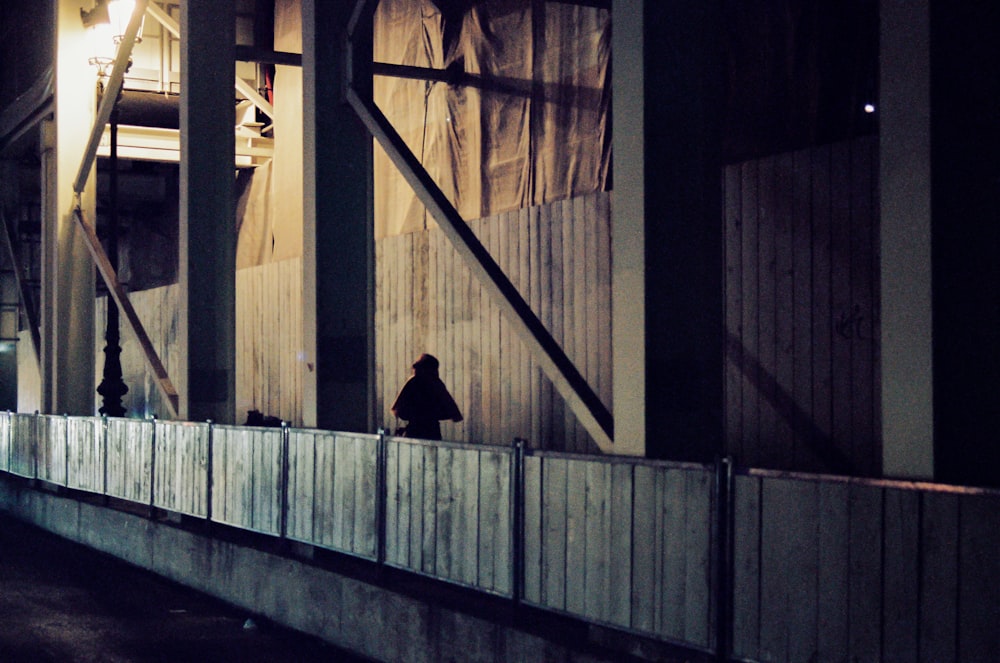 person in black jacket walking on the hallway